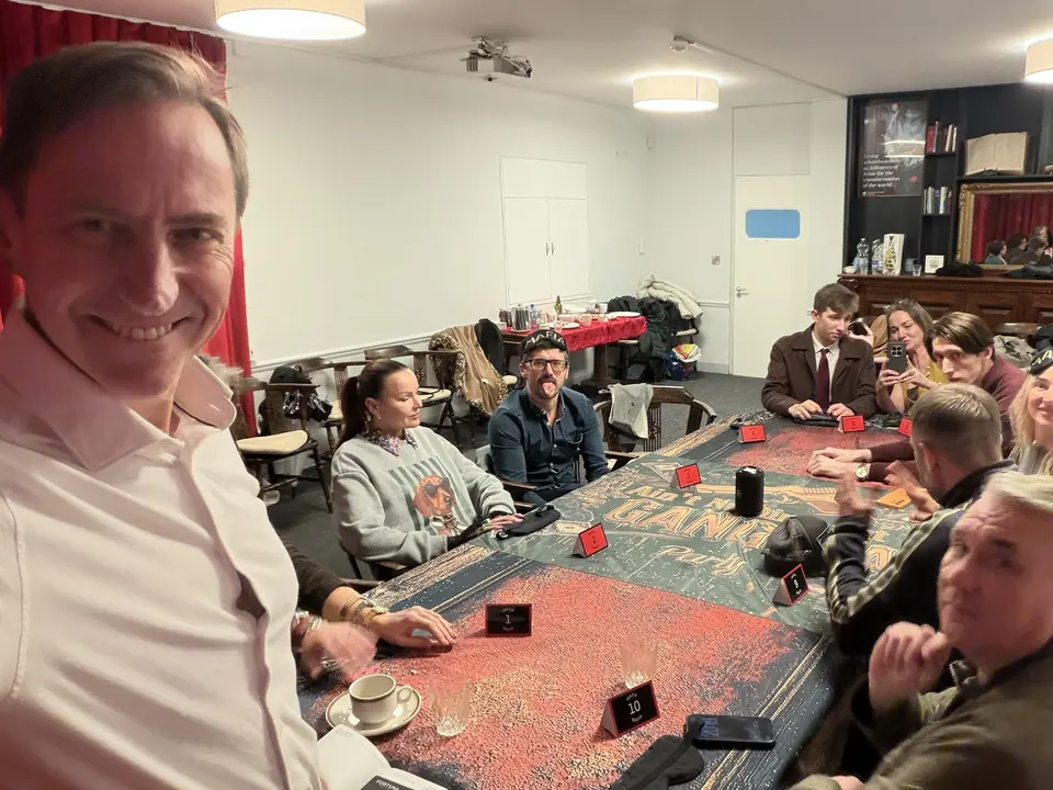 A guest takes a selfie at the long game table