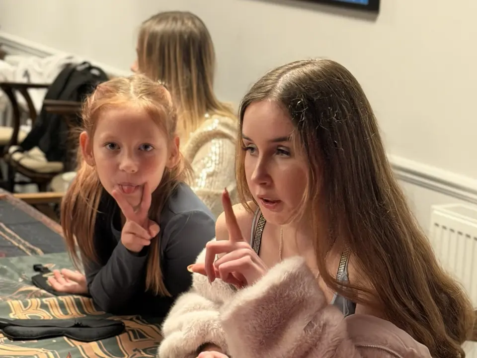 Two young guests at the game table