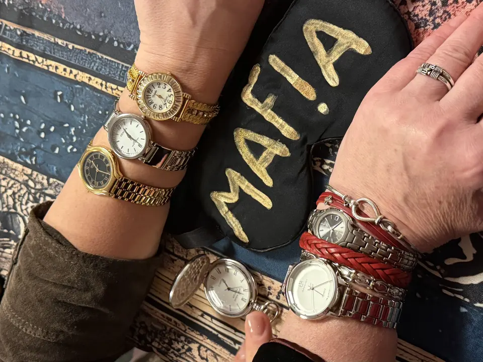 A black mask with the word MAFIA in a player's hands