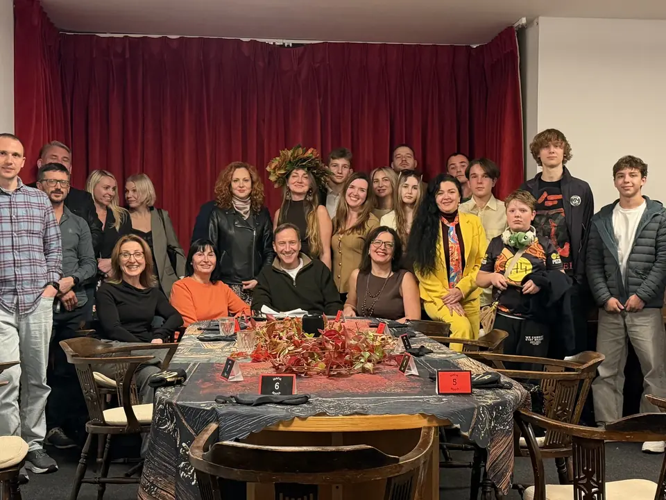 A group photo of club guests at the game table